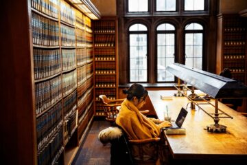 A student works in the Myron Taylor Hall Library