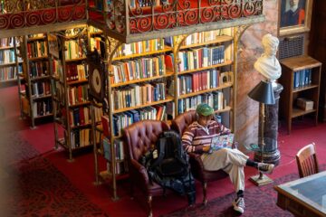 A student works on a laptop in the A.D. White Library
